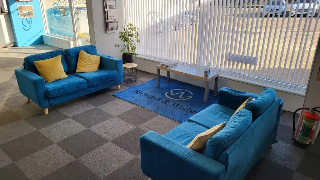Blue sofas and hot drink area in the Stewart & Wisbey customer lounge