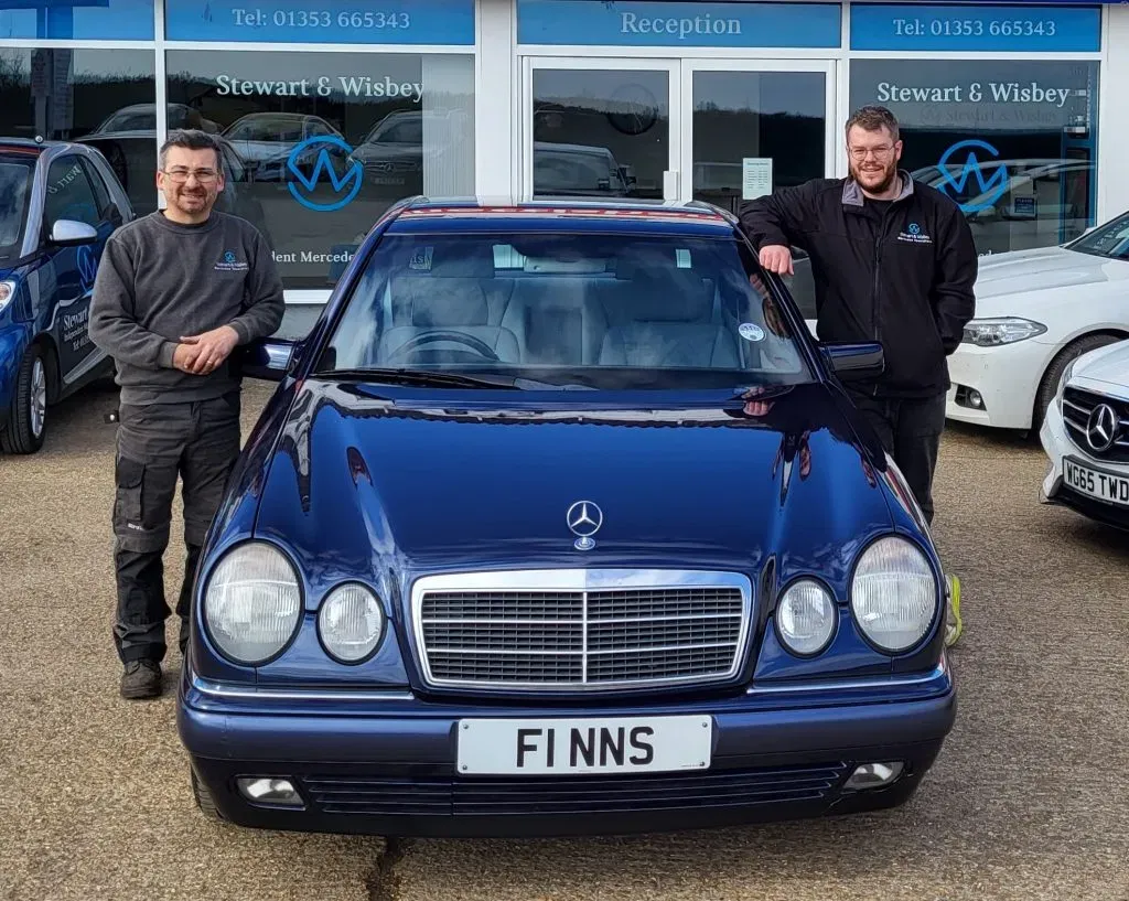 The Stewart & Wisbey team with a Mercedes-Benz outside the workshop